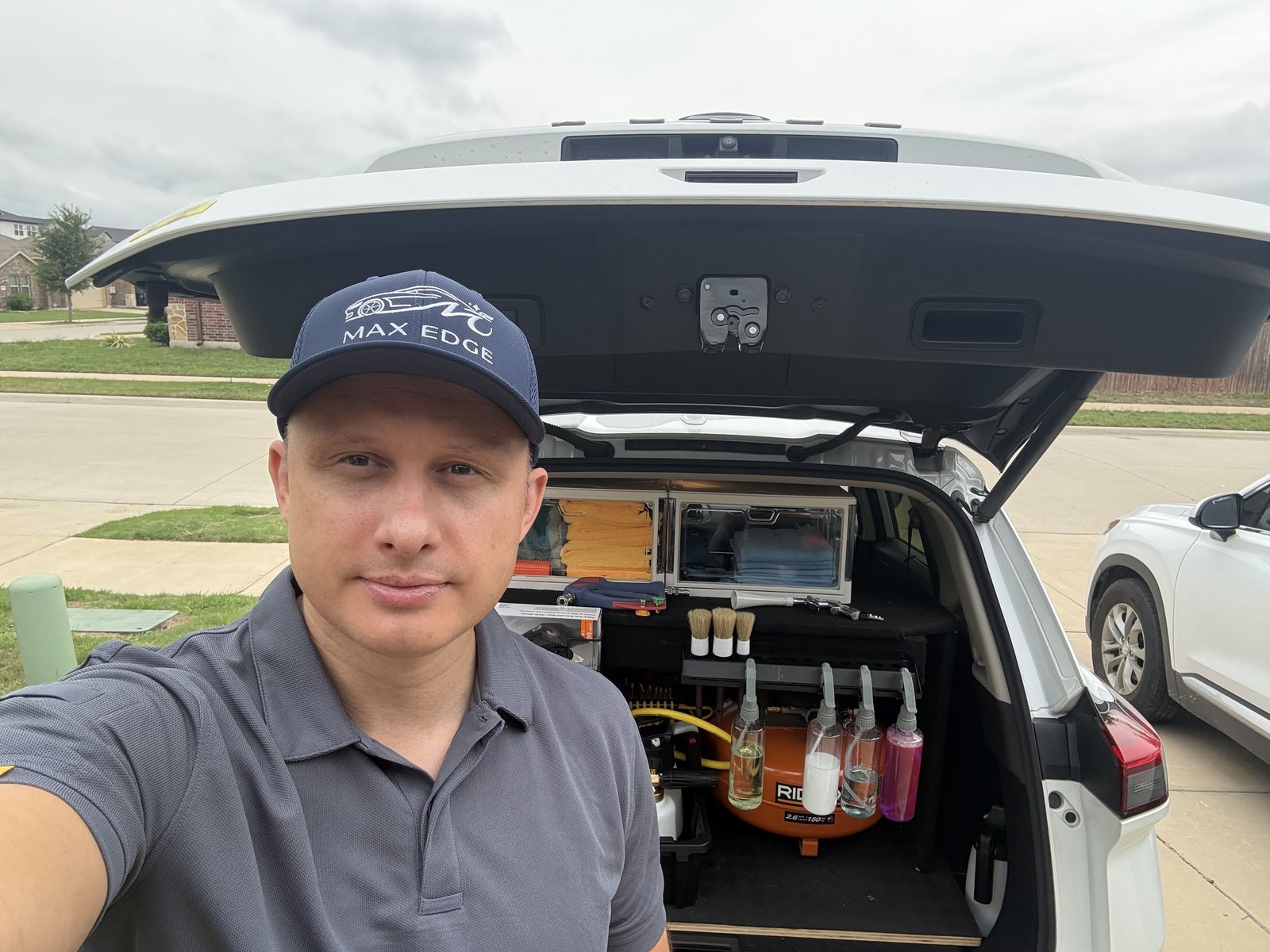 Maksym, owner of Max Edge Mobile Detailing in Argyle TX, with professional detailing equipment